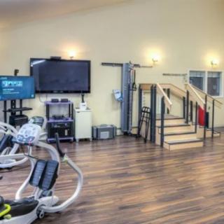 A well-equipped gym with modern exercise machines and workout space.