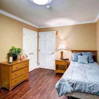 A cozy bedroom with wooden furniture and warm-toned walls.