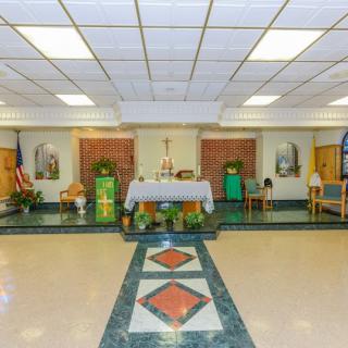 A chapel interior with an altar and religious decorations.