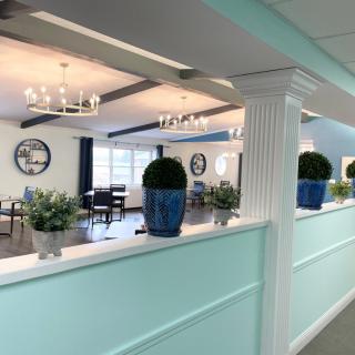 A stylish and modern dining area featuring decorative plants and elegant chandeliers.