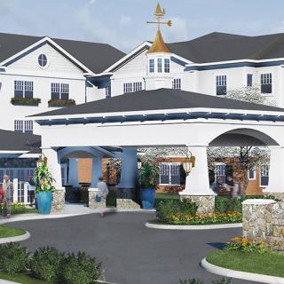 A beautifully designed residential building with a landscaped entrance and clear sky.