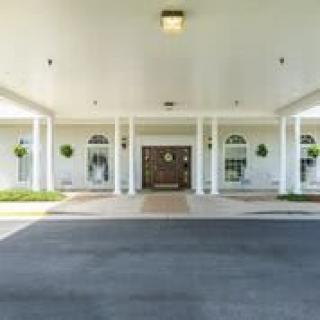 A building entrance with columns and a covered driveway.
