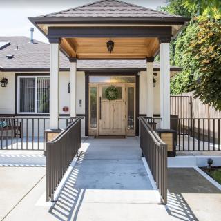 Front entrance of a residential house featuring a ramp and covered porch.