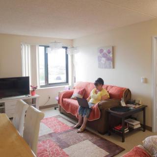 A cozy living room with a person reading on the couch.