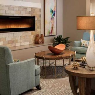 A cozy and modern living room featuring comfortable seating, a warm fireplace, and tasteful decor.