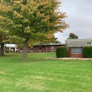 A view of a residential complex with trees changing colors in the autumn.