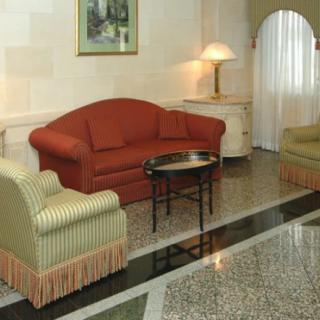 A cozy living room with a red sofa, armchairs, and a coffee table.