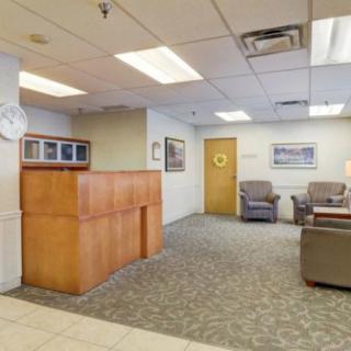 A spacious waiting area with comfortable seating and a reception desk.