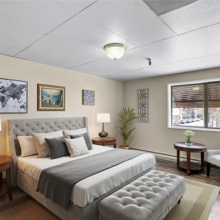 A modern and well-lit bedroom with stylish decor and comfortable furnishings.