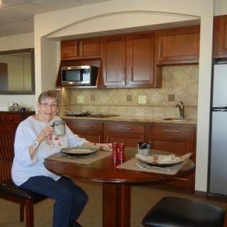 A woman enjoying a meal at a cozy kitchen table.