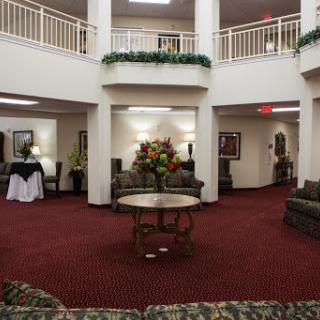 A spacious lobby with elegant seating and decorative floral arrangements.