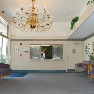 Elegant lobby with a grand chandelier and cozy seating area.