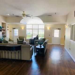 A spacious living room with modern furniture and large windows.