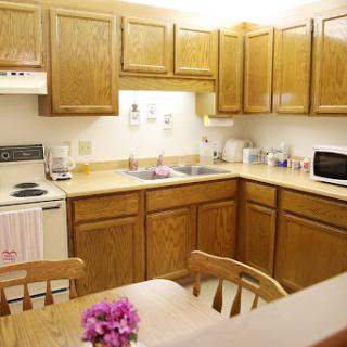 A cozy kitchen with wooden cabinets and a small dining area.