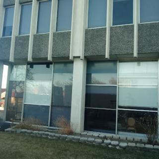 A modern building showcasing a combination of concrete and glass elements.