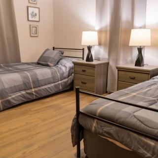 A cozy bedroom with twin beds and stylish decor.