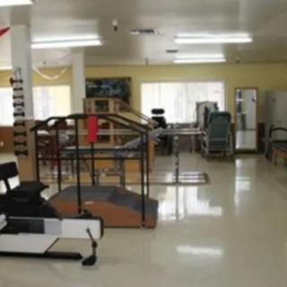 A physical therapy and rehabilitation room equipped with various exercise machines.