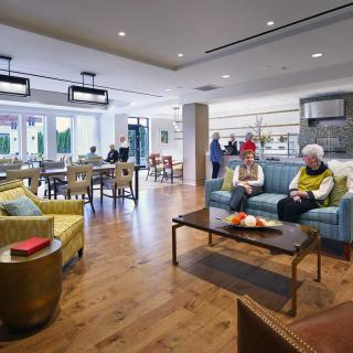 A spacious, modern living area with people relaxing and socializing.
