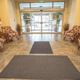 A welcoming lobby entrance with comfortable seating and glass doors.