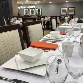 A neatly arranged dining table with elegant table settings in a restaurant.