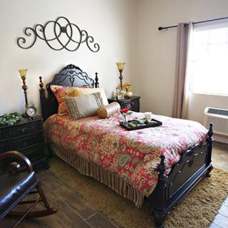 A well-decorated bedroom with a single bed and traditional furnishings.