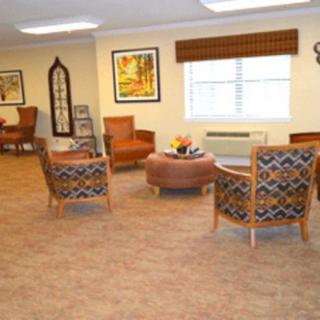 A cozy seating area with patterned chairs and a window.