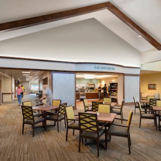 A cozy dining area featuring tables and chairs, designed for community gatherings.