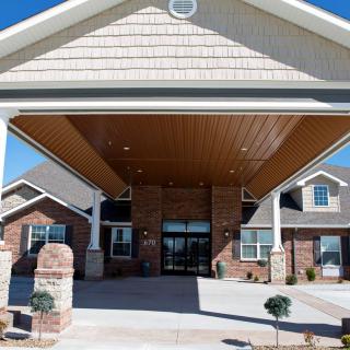 Front entrance of a modern brick building with white columns.
