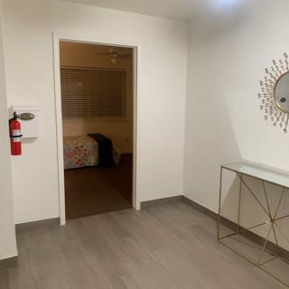 A modern interior with minimalist decor featuring a console table and mirror.