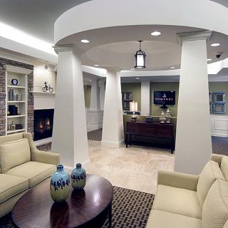 A modern living room with elegant furniture and a cozy fireplace.