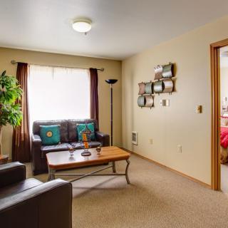 A cozy living room with comfortable seating and inviting decor.