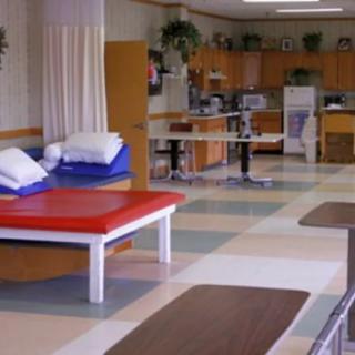 A physical therapy room equipped with treatment tables and exercise equipment.