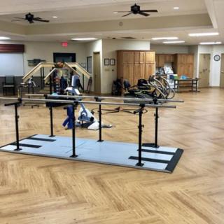 A physical therapy room equipped with rehabilitation equipment.