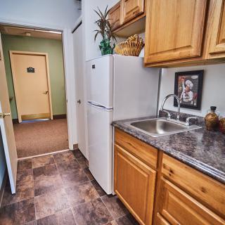 A cozy kitchen with wooden cabinets and a modern sink.