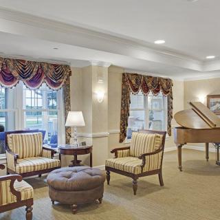 Elegant living room with a grand piano and classic furniture.