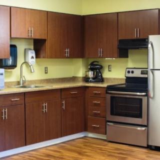 A modern kitchen with wooden cabinets and stainless steel appliances.