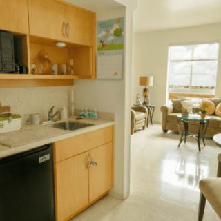 A modern apartment with an open kitchen and a cozy living area.