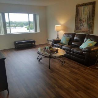 A cozy living room with a large window, comfortable seating, and stylish decor.