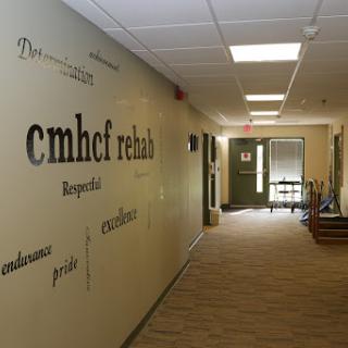 A corridor in a rehabilitation facility, featuring motivational wall art.