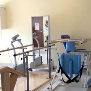 A physical therapy room equipped with rehabilitation equipment.