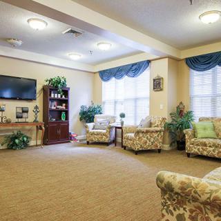 A cozy living room with comfortable seating, a TV, and decorative elements.