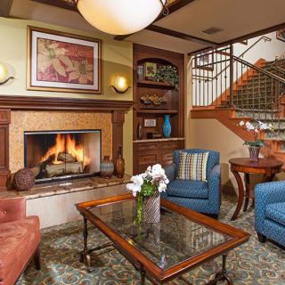 A cozy living room with a warm fireplace and comfortable seating.