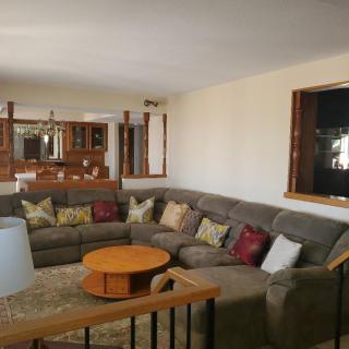 Cozy living room with a large sectional sofa and coffee table.