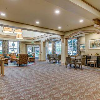 A spacious, well-lit lobby with comfortable seating and large windows.