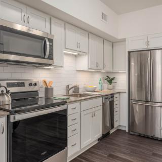 Modern kitchen with stainless steel appliances and sleek cabinetry.