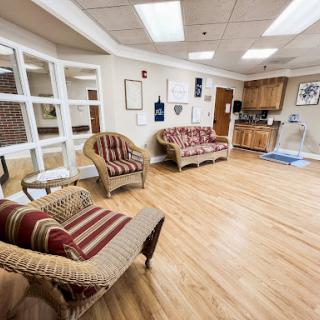 A cozy lounge area featuring comfortable seating and a kitchenette.