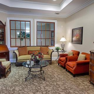 A cozy living room with sofas, chairs, a coffee table, and decorative elements.