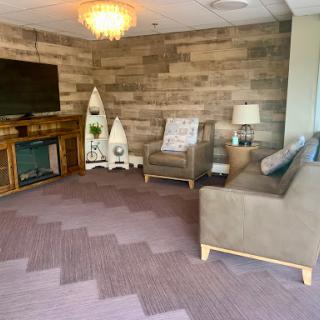 A cozy lounge area featuring a blend of modern and rustic design elements.