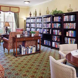 A cozy library with bookshelves and comfortable seating.