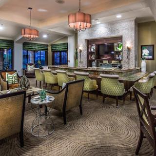 A cozy and modern lounge area featuring comfortable seating and elegant lighting.